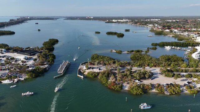 Boats passing through a historic swing bridge at Blackburn Point near Casey Key in Sarasota, Florida. 