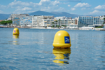 Yellow buoys marking safe swimming zone in antibes, france © Kristof