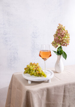 Rose wine glass with grapes and hydrangea flowers
