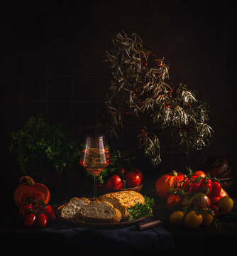 Autumnal still life with wine, bread, and harvest vegetables