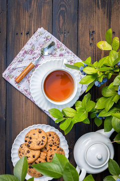 Tea, cookies, and blueberries on wooden table