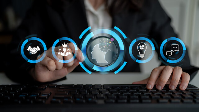 A business professional interacts with a keyboard while engaging with digital icons that symbolize technology, communication, leadership, and innovation in a modern workplace setting. Nascent