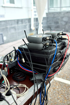 Closeup view of improvised explosive device wiring with colored wires and cylindrical components on rooftop concrete parapet with urban background in daylight