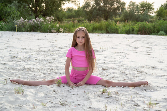 Young gymnast training outdoors at sunset