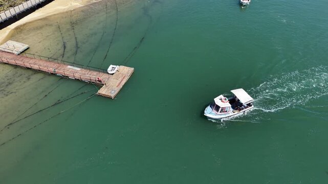 Aerial view of tour boat docking at wooden pier in portugal