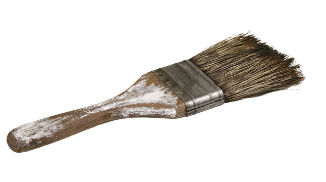 Isolated worn wooden handle paintbrush with dirty bristles and dried white paint
