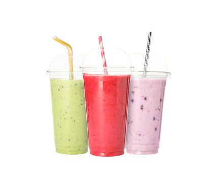 Yummy milk shakes in plastic cups on transparent background