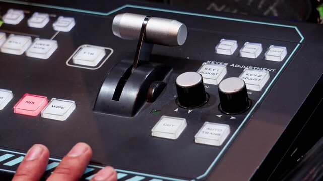 Broadcast video switcher operator working on control panel
