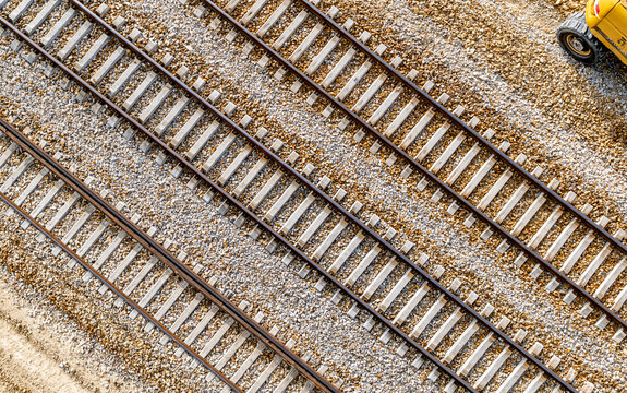 High angle view of parallel railway tracks with gravel and concrete sleepers