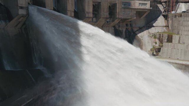 Inguri hydropower dam water discharge outlet Georgia renewable energy infrastructure, powerful release, hydroelectric engineering, mist, rainbow and river flow.