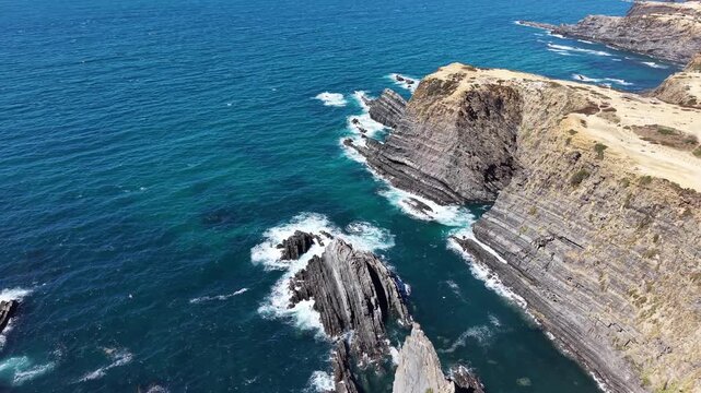 Aerial view of cabo sard&atilde;o cliffs crashing waves