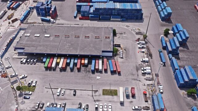 Miami, Florida, USA - May 30, 2025: Cargo services with container in Miami port top view. Freight container cargo. Port of Miami. Container port loading. Export and import. Cargo business