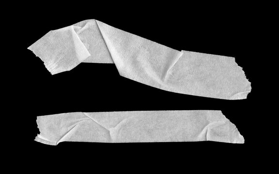 Two pieces of white adhesive tape with a textured surface and wrinkled edges, isolated on a black background.