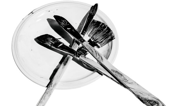Isolated artist paintbrushes and palette, monochrome art supplies, creative hobby tools