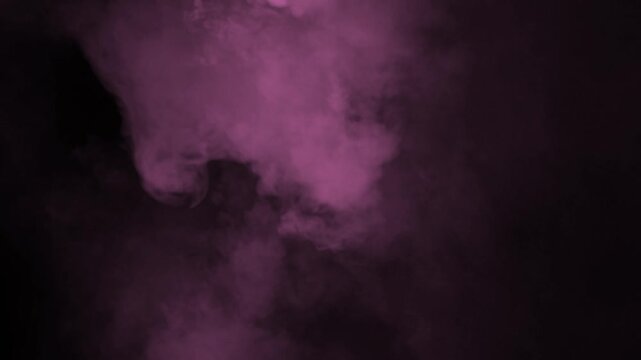 Soft pink smoke cloud expanding down from top frame on black background
