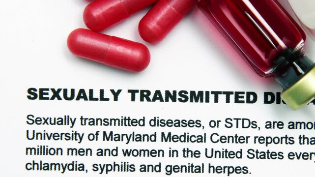 Close up of pills and blood vial on sexually transmited disease