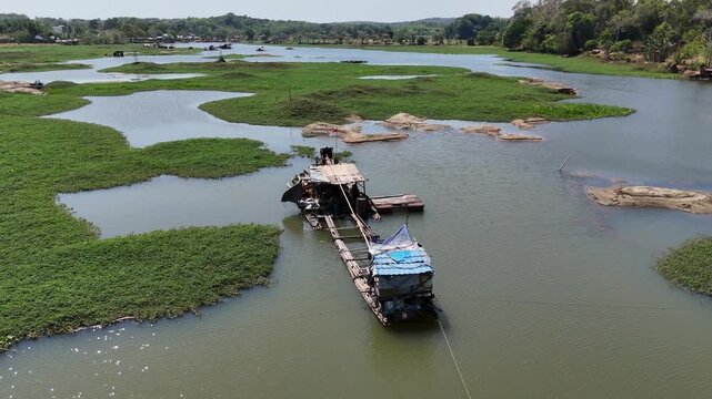 Floating bamboo houses for gold mining on a river in South Kalimantan, Indonesia.