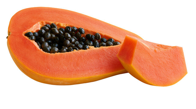 Isolated ripe papaya cut in half with dark seeds and a fresh slice, tropical fruit.