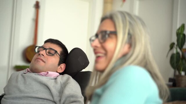 Mother having fun and laughing with disabled son