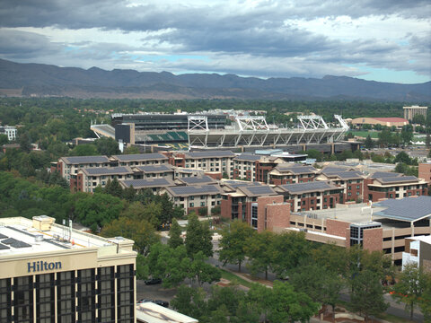 Fort Collins, Colorado, USA, 07, September 2026 An elevated view showing the Hilton Fort Collins hotel in the foreground and the Colorado State University Canvas Stadium in the background.