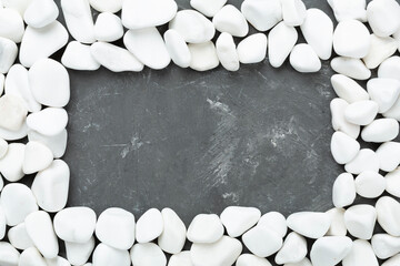 White pebble stones on concrete background, top view © Liami