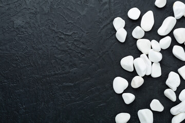 White pebble stones on concrete background, top view © Liami