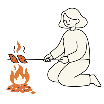 さつまいもを焼く女性
