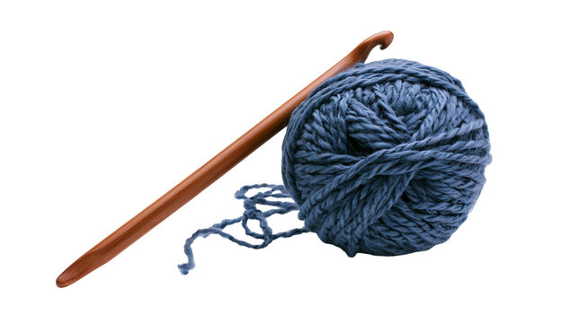 Isolated wooden crochet hook and a beautiful ball of chunky blue yarn for handicraft.