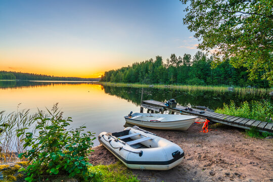 Hallangen lake pier with boats at sunset. Kalmar region. Sweden