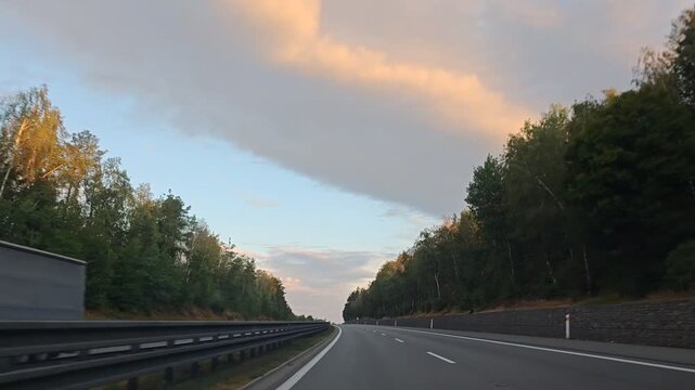 Open highway from Prague to Plzen beneath dramatic sunset clouds