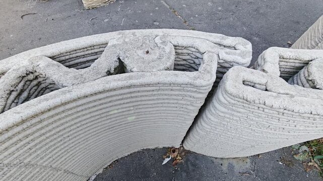 Curved 3D printed concrete wall modules demonstrating additive construction