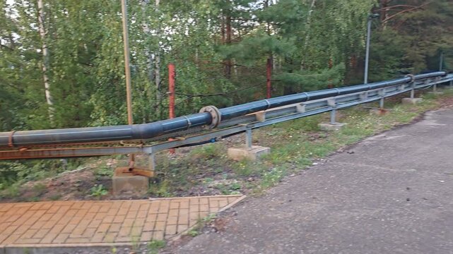 Turkank Mine in Kutna Hora with industrial pipelines through woodland