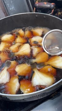 Ladling Soy Broth Over Simmering Filefish, Japanese Simmered Fish, Izakaya Japan