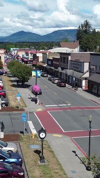 Aerial view of downtown Arlington, Washington, a vibrant small town in the Pacific Northwest. Vertical design in 9:16 ratio. Smartphone and social media ready.