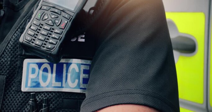 Police officer &ndash; emergency services law enforcement agent wearing uniform, radio and badge on duty. Involved in arrest, investigation and community support.
