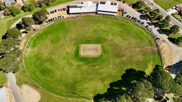 Strathalbyn Oval, South Australia &ndash; 4K Aerial Drone View of Australian Rules Football Ground, Sports Club, club facilities, parked vehicles, trees and the regional township