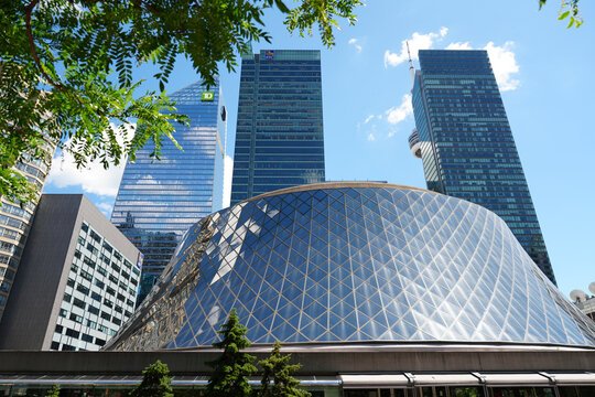 Toronto, Canada - June 23, 2026: Roy Thomson Hall with modern skyscrapers and CN Tower on sunny summer day