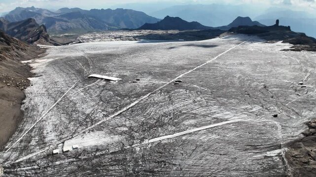 Scenic footage of the Glacier 3000 alpine landscape in Switzerland, featuring expansive glaciers, snow-covered mountains and dramatic high-altitude scenery in the Swiss Alps.
