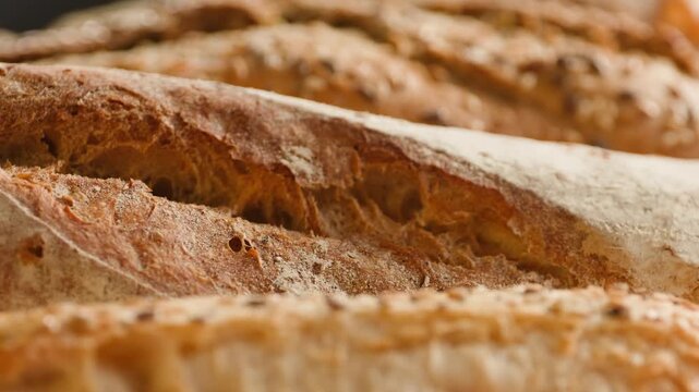 Baguette Bread torn apart by hand, fresh baguette crumb close-up macro shot showing soft airy texture