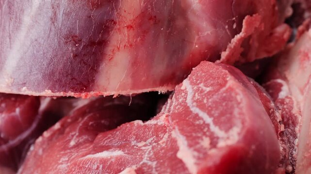 Fresh beef ossobuco steak with salt, spices and herbs on textured background, bones. 