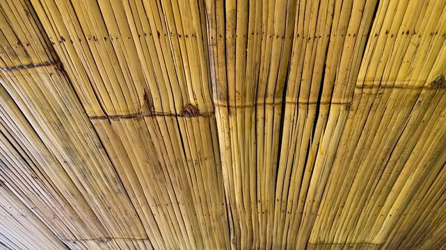 Handcrafted bamboo ceiling panels showing intricate patterns and light brown natural wood colors