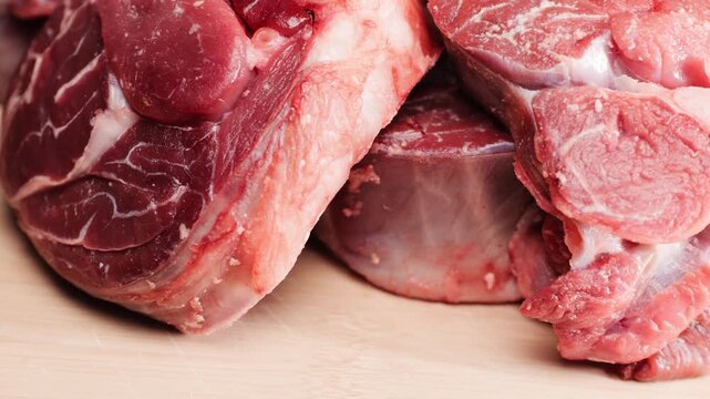 Fresh beef ossobuco steak with salt, spices and herbs on textured background, bones. 