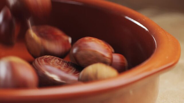 Fresh chestnut, supermarket food, Oven roasted chestnuts with sliced peel on wooden board, spanish traditional winter dish.