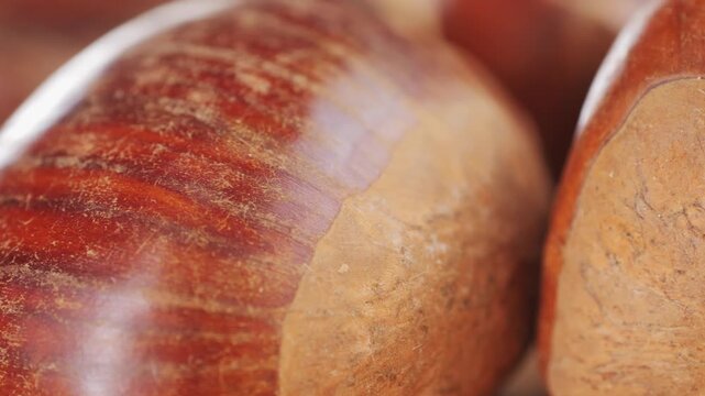Fresh chestnut, supermarket food, Oven roasted chestnuts with sliced peel on wooden board, spanish traditional winter dish.