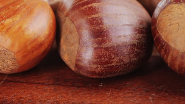 Fresh chestnut, supermarket food, Oven roasted chestnuts with sliced peel on wooden board, spanish traditional winter dish.