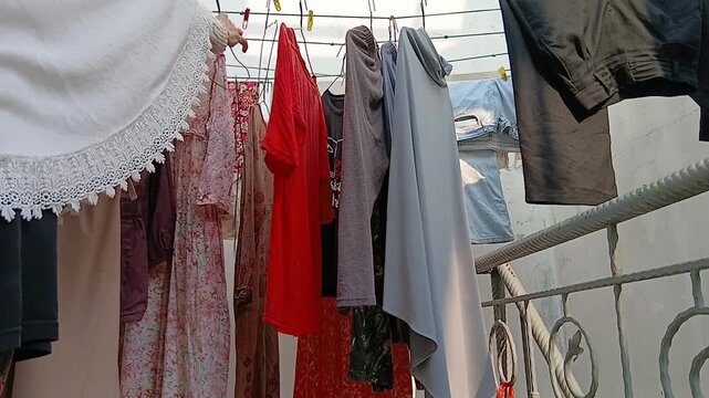 Hanging Clean Clothes on a Clothesline to Dry Outdoors