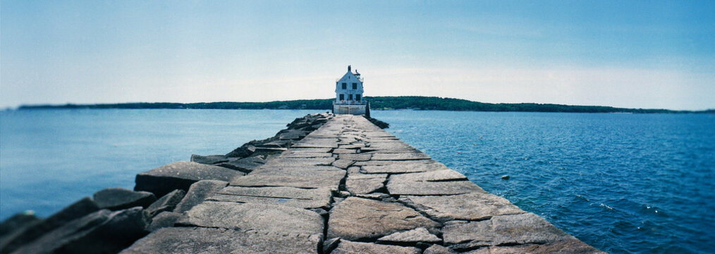 Panoramic view of the historic Rockland Harbor Breakwater Light sitting at the end of a nearly one-mile granite stone causeway in Rockland, Maine