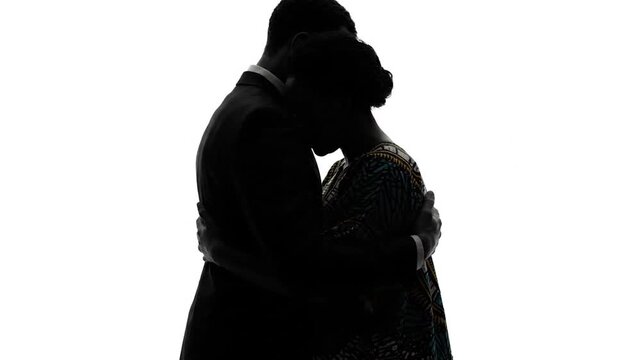 Silhouette of romantic couple facing each other.