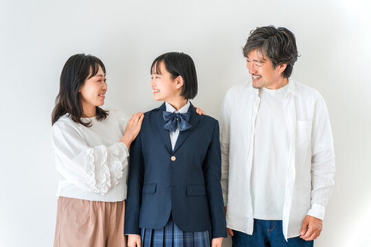 Smiling Parents with Their High School Daughter in Uniform, Family of Three Celebrating School Admission and a New Academic Journey