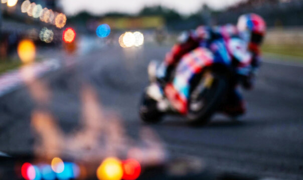 A motorbike racing on a track, with dynamic motion blur effects. The scene captures the excitement of motorsport, showcasing speed and skill during a competition.